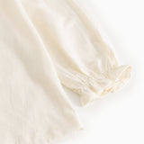 Offwhite bluse med pufærme og elastisk manchet