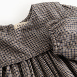 Houndstooth-kjole med flæset krave og rynket brystparti, detalje nærbillede