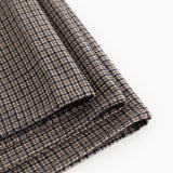 Airo tørklæde med houndstooth-tern, synlig frynsekant og fold i brun og blå